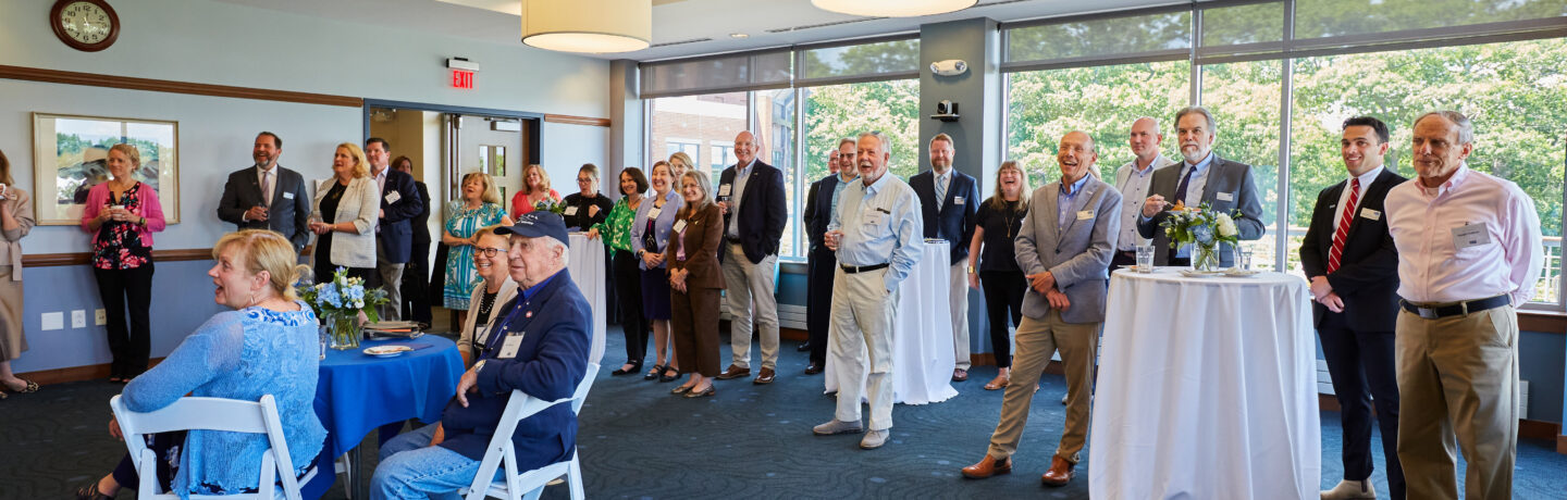 A group of U NE employees and guests celebrate the 100th birthday of George H. W. Bush
