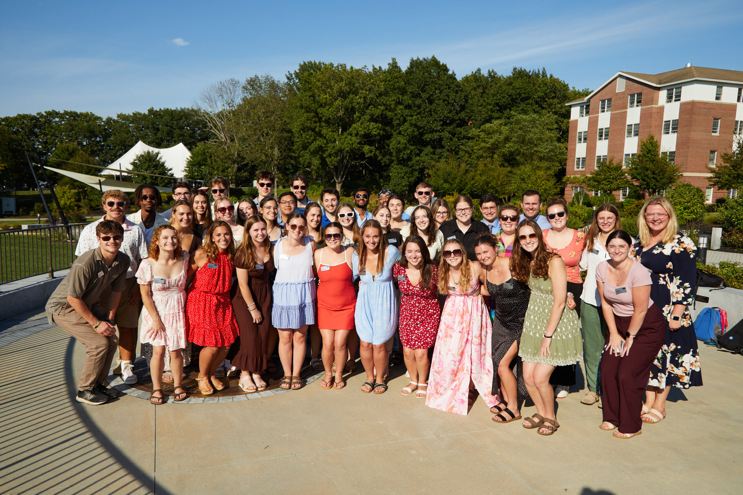 A large group of students pose together on the Biddeford Campus