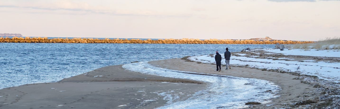 Walking along winter beach